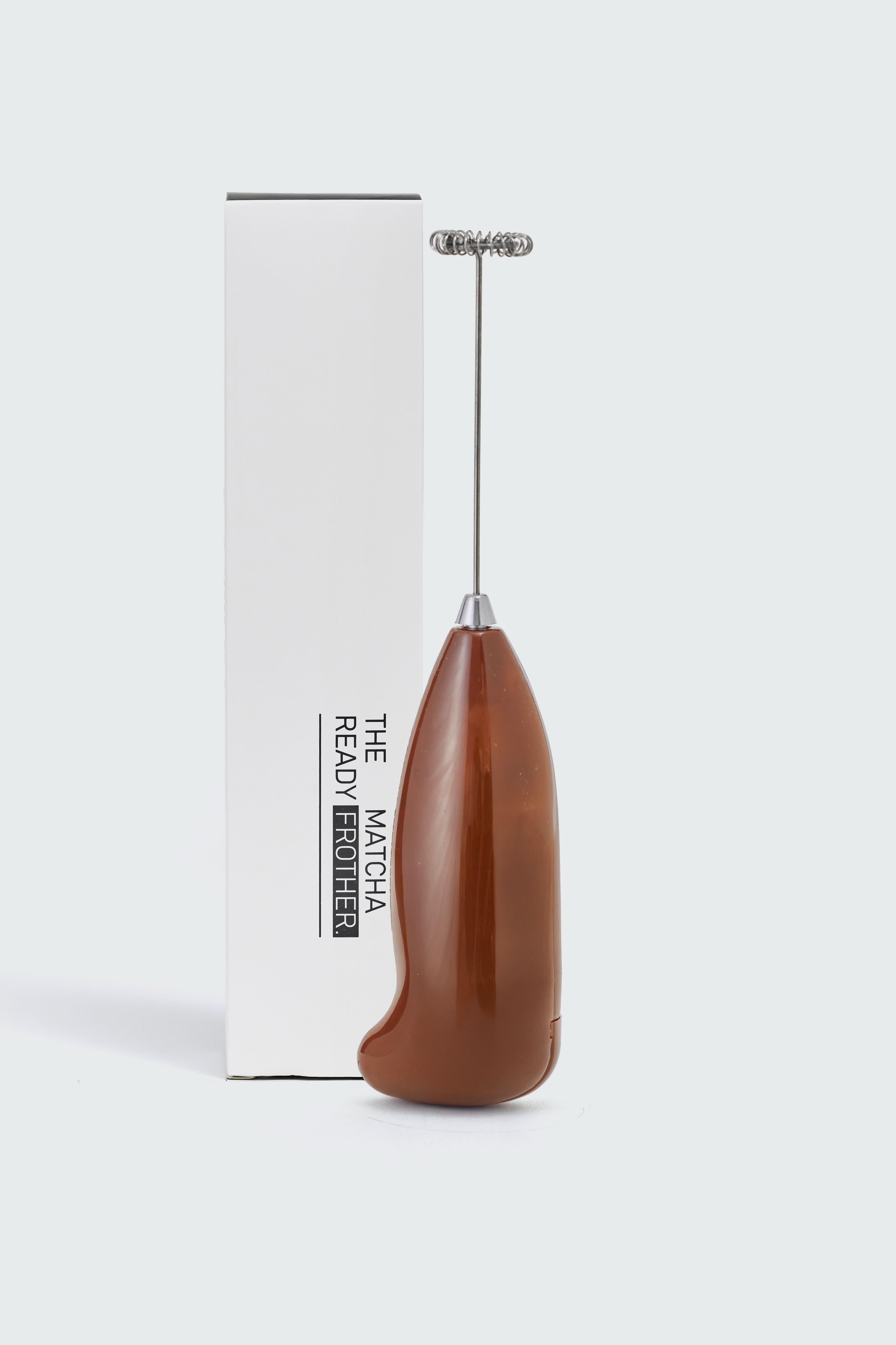 Battery-powered milk frother by Matcha Ready, showing the compact device with a stainless steel whisk and control button.
