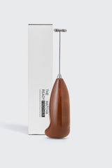 Battery-powered milk frother by Matcha Ready, showing the compact device with a stainless steel whisk and control button.